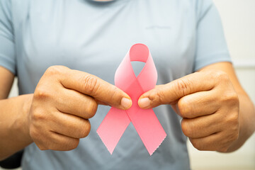 Breast cancer, pink ribbon at Asian senior lady for supporting awareness, symbol of World Breast Cancer Day.