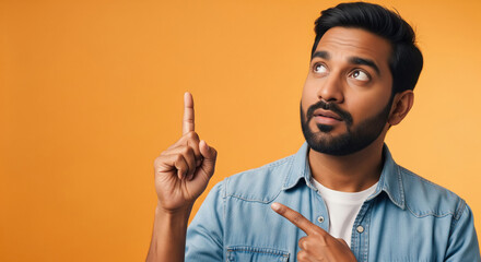 Young happy man pointing finger