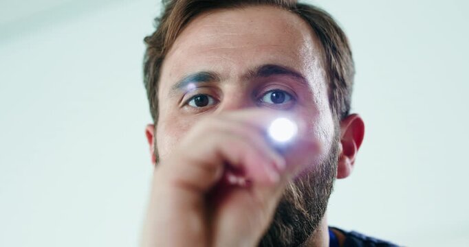 Eye exam, light and doctor with face of man in hospital for pupil reflex, concussion check and healthcare pov. Optic nerve damage, consulting and medical help with person and penlight in clinic