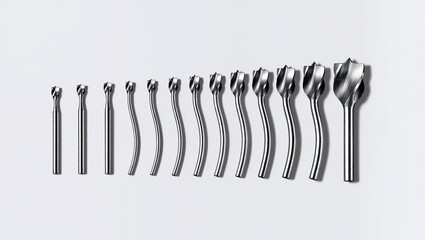 Metal drills lined up on a light background