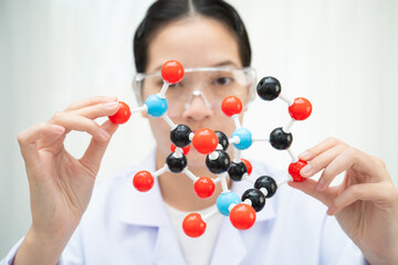 Scientist holding molecular model for chemical technology.