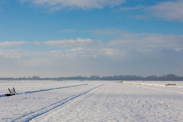 Winter countryside landscape, White fluffy snow covered on green grass meadow and trees, Typical Dutch polder with flat and lowland, canals and ditch, Abcoude in the province of Utrecht, Netherlands.