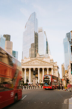 Red double decker buses moving through central London streets.