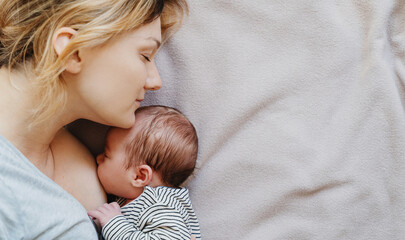 Mother breastfeeding baby. Baby eating mother's milk.