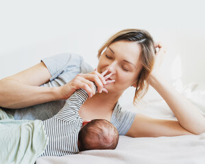 Mother breastfeeding baby. Baby eating mother's milk.