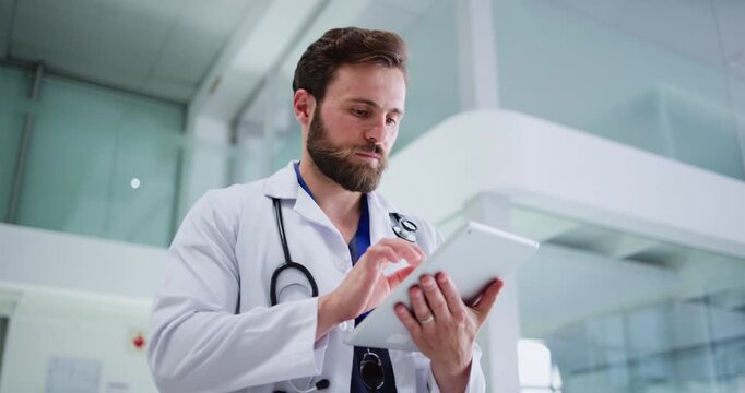 Doctor, walking or man with tablet in hospital, update medical records or access patient history info. Treatment planning, tech or physician with online test results for healthcare, typing or below