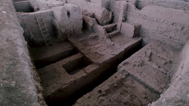 India archaeological excavation showing deep trenches, ancient brick foundations, ladder access and preserved structures used for heritage research, history education, museum content.