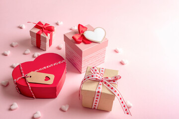 Gift boxes with red and pink hearts on a pastel pink background. Valentine s Day celebrations. Top view, copy space