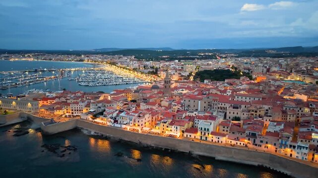 Aerial view of evening seaside fortress, scenic drone footage captures italian coast fortress during sunset evening. Algero