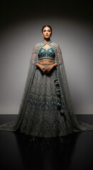 young indian woman wearing traditional jewelery standing on isolated background