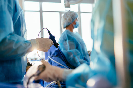 Gynecological laparoscopic surgery with medical team monitoring procedure in operating room