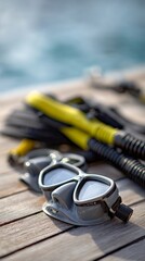 Fototapeta premium Diving mask and snorkel resting on a wooden dock, inviting a refreshing plunge into the crystal clear blue sea, hinting at an exciting underwater adventure ahead