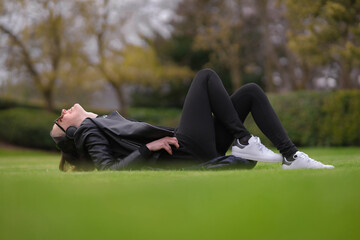 Woman enjoying a sunny spring day in the park. Happy woman outdoors. Fresh start, springtime joy