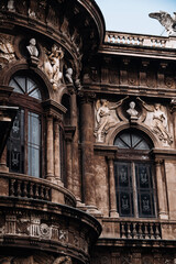 Historic Stone Archway In Italian City: Ornate Facade With Arched Passage, Decorative Windows, And Weathered Classical Architecture