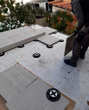 laying outdoor tiles on terrace or balcony using rectifying targets. sintered tiles are resistant to frost, mechanical damage. Rectification targets  pad allow for smooth height adjustment , unboxing