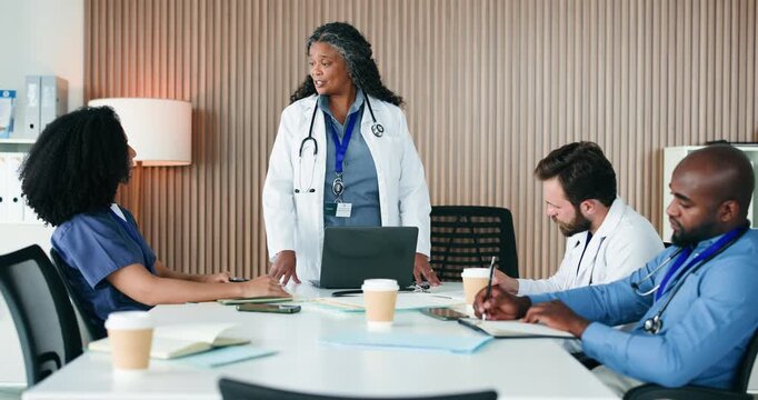 Discussion, manager or doctors writing in boardroom, administration or operational planning for practice. Private facility, committee meeting or clinic director with update for team, people or laptop