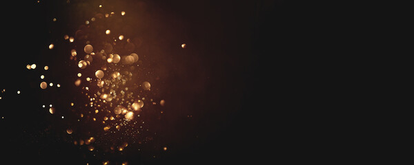 Golden abstract bokeh on black background. Holiday concept