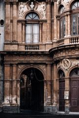 Historic Stone Archway In Italian City: Ornate Facade With Arched Passage, Decorative Windows, And Weathered Classical Architecture