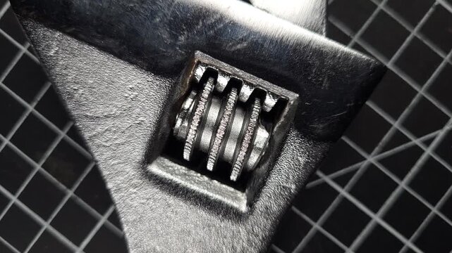 Adjustable wrench gear mechanism with metal worm screw, close-up.