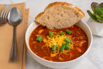 chilli macaroni  top with freen onions and cheese