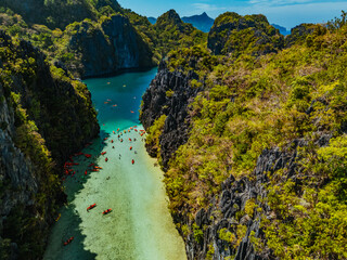 Crystal-clear turquoise water surrounded by dramatic limestone cliffs in the Big and Small Lagoons of Palawan