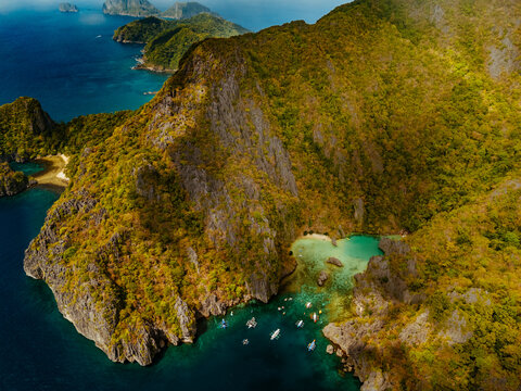 Crystal-clear turquoise water surrounded by dramatic limestone cliffs in the Big and Small Lagoons of Palawan