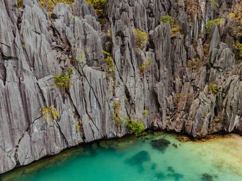 Crystal-clear turquoise water surrounded by dramatic limestone cliffs in the Big and Small Lagoons of Palawan