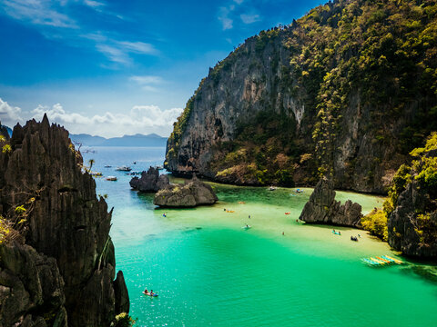 Crystal-clear turquoise water surrounded by dramatic limestone cliffs in the Big and Small Lagoons of Palawan
