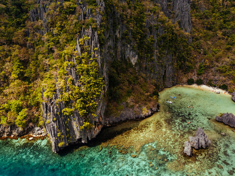 Crystal-clear turquoise water surrounded by dramatic limestone cliffs in the Big and Small Lagoons of Palawan