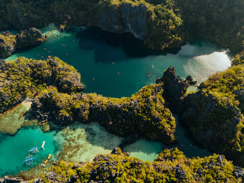 Crystal-clear turquoise water surrounded by dramatic limestone cliffs in the Big and Small Lagoons of Palawan