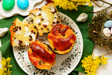 Traditional  Easter pastry kraffin with cottage cheese and raisin on Easter background and painted eggs.