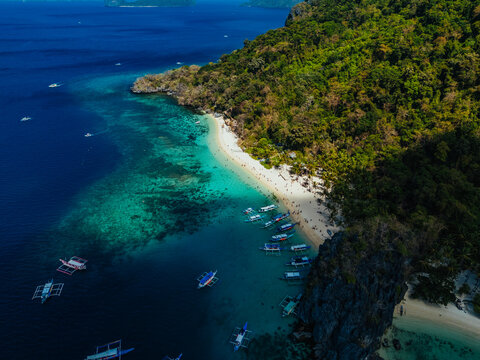 White sand beach with calm turquoise water and lush tropical scenery, capturing the natural beauty of the Philippine coastline