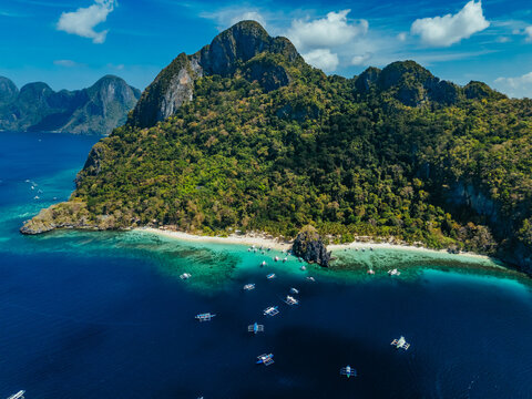 White sand beach with calm turquoise water and lush tropical scenery, capturing the natural beauty of the Philippine coastline