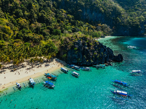 White sand beach with calm turquoise water and lush tropical scenery, capturing the natural beauty of the Philippine coastline
