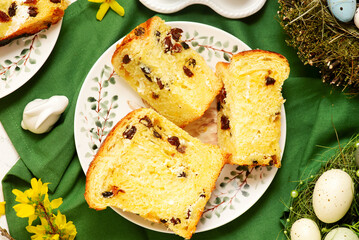 Traditional  Easter pastry kraffin with cottage cheese and raisin on Easter background and painted eggs.