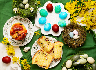Traditional  Easter pastry kraffin with cottage cheese and raisin on Easter background and painted eggs.