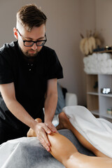 Physiotherapist performing leg massage for muscle recovery