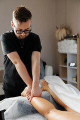 Physiotherapist performing leg massage for muscle recovery
