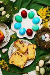 Traditional  Easter pastry kraffin with cottage cheese and raisin on Easter background and painted eggs.