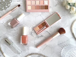 Beauty makeup tools and cosmetics flat lay in soft pink tones