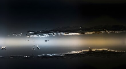 Abstract photograph captures glistening rivulets of water flowing down a dark reflective surface creating dramatic light streaks