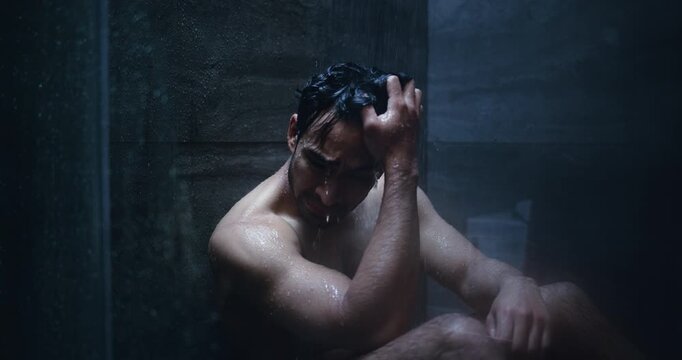 Thinking, sad and man in shower crying for disappointment, failure and crisis in home. Bathroom, dark and person with depression, reflection and thoughtful for mental health, mistake and frustrated
