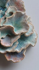 Beautiful handmade ceramic coral sculpture in various shades of blue and pink on display