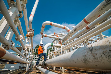 Male worker inspection at steel long pipes and pipe elbow in station oil factory during refinery valve of visual check record pipeline