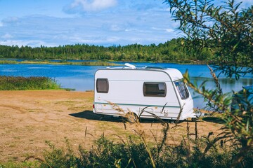 Scenic Lakeside Setting Featuring a Cozy Caravan Amidst Nature's Calm Serenity