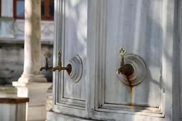 Bronze fountain on marble stone at the mosque fountain