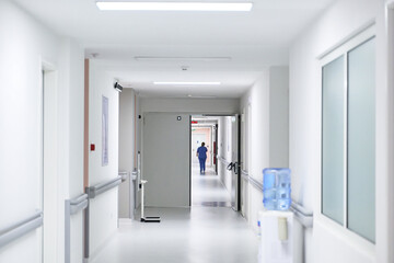 Nurse walking down a hospital corridor during daytime work hours in a healthcare facility