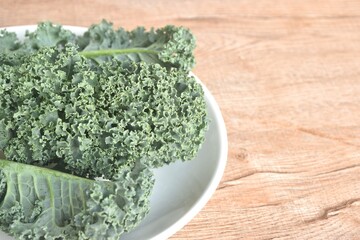 fresh green Curly Kale vegetable salad with drop of water arranging on plate