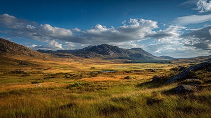 Scenic landscape of the Scottish Highlands with picturesque mountains under a blue sky.