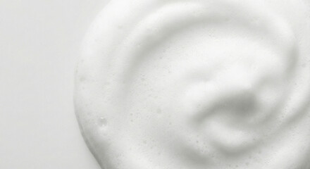 Close-up of smooth white cream texture on light background
